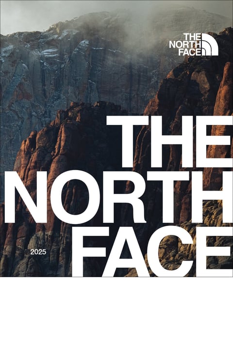 The North Face 2025 catalog cover featuring dramatic rocky mountain cliffs with mist and The North Face logo
